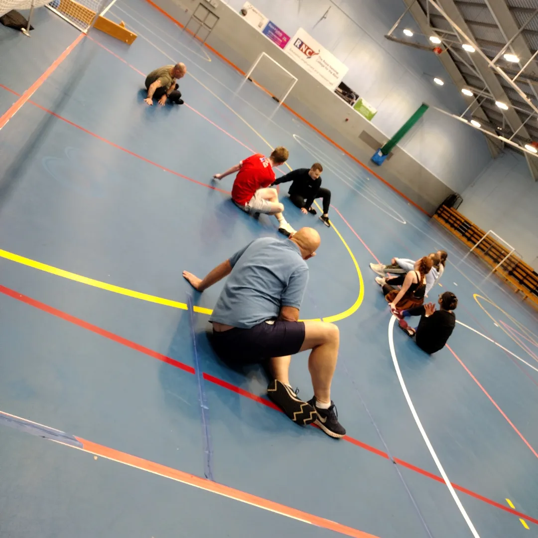 A young male is trying indoor archery